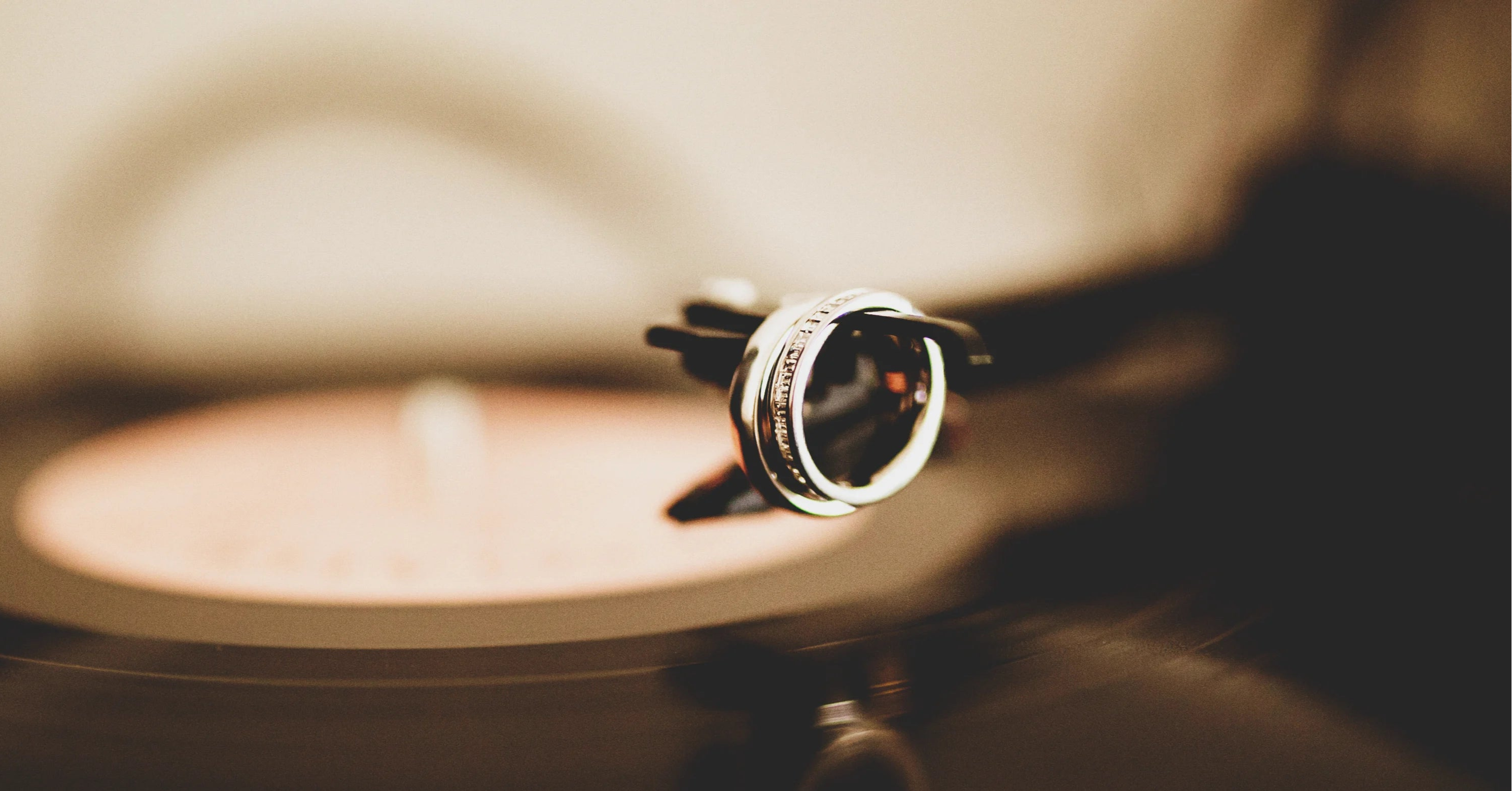Close-up of a vinyl record with a turntable needle on a dark background